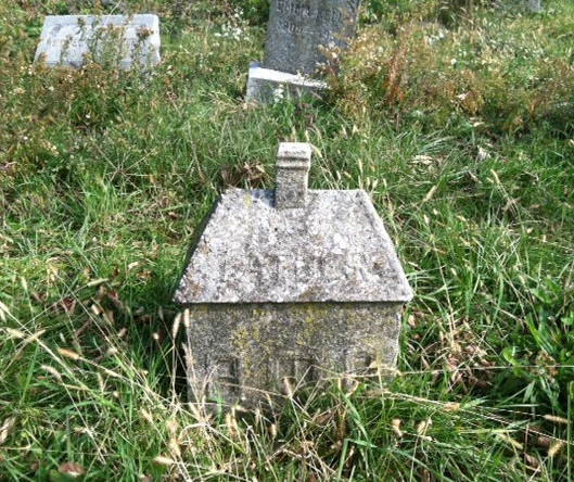 This little house stood out among the other graves and is now one of my favorites. I wonder if the person who it was made for built homes.