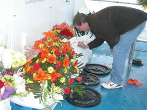 A guest at a sea burial signs a shroud before it is placed in the ocean. Photo courtesy of New England Burials at Sea