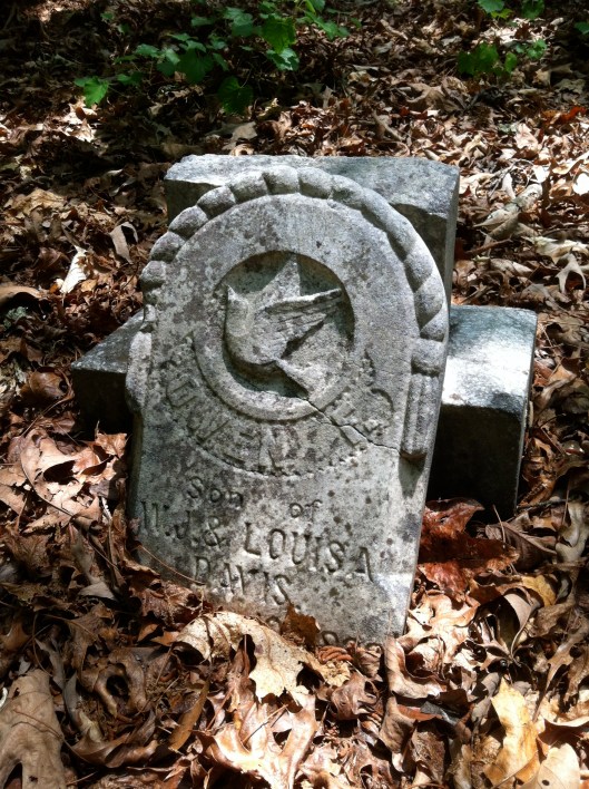 This broken monument features a dove motif, a symbol of peace. It was carved for a child.