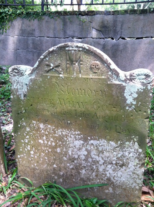 The headstone of infant Esther Whay Gordon features crossed bones, an hourglass and a skull. She died in 1792, having lived only one  year, four months and 29 days. She is buried in the Circular Congregational Church Burial Grounds. 