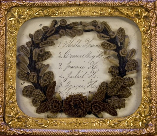 This framed wreath is made out of hair from the ladies listed inside of it. Photo courtesy of Leila' Hair Museum. 
