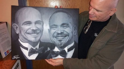 A pleased client shows off the portrait of his late partner painted with traces of his ashes. Photo courtesy of Adam Brown's website Adam Brown's Gallery.