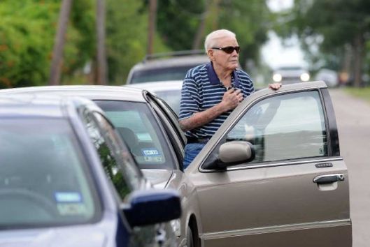 An elderly gentleman stops to show his respect during the funeral procession of a Beaumont, Texas police officer killed in the line of duty. Photo courtesy of Guiseppe Barranco/The Enterprise.