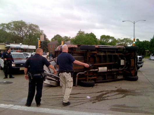 This van, which was traveling in a funeral procession in Milwaukee, Wisc., was overturned when a pickup truck slammed into it. Photo courtesy of Tom Held/Journal-Sentinel.