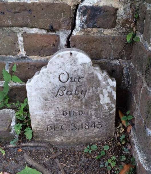 A nameless infant's grave rests in the corner of the Coming Street Cemetery in Charleston, S.C.