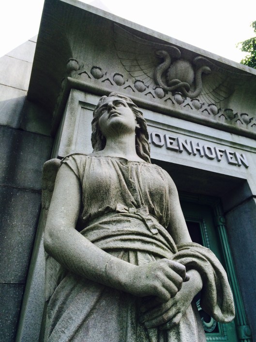 At one time, the angel to the left of the tomb's door held a key. It's not longer there.