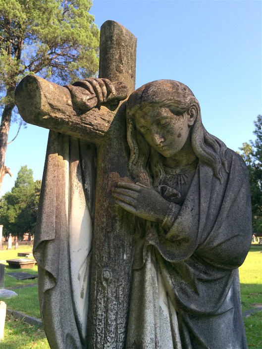 This angel leaning on a cross stands over the grave of Ann Kinchley Austin.
